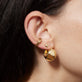 Model wearing Small Gold Puff Heart Stud Earrings with solid gold Stone and Strand jewelry