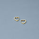 Stone and Strand 14K Yellow Gold Gold Heart Huggie Single Earring Editorial Image