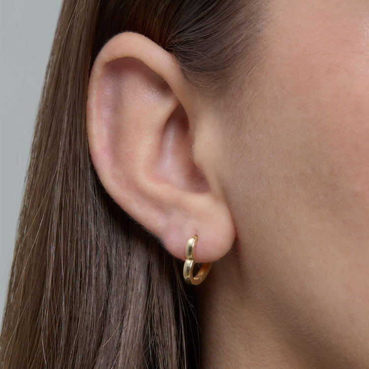Image of 14K Yellow Gold Gold Heart Huggie Single Earring on Models Ear