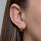 Image of 14K Yellow Gold Gold Heart Huggie Single Earring on Models Ear
