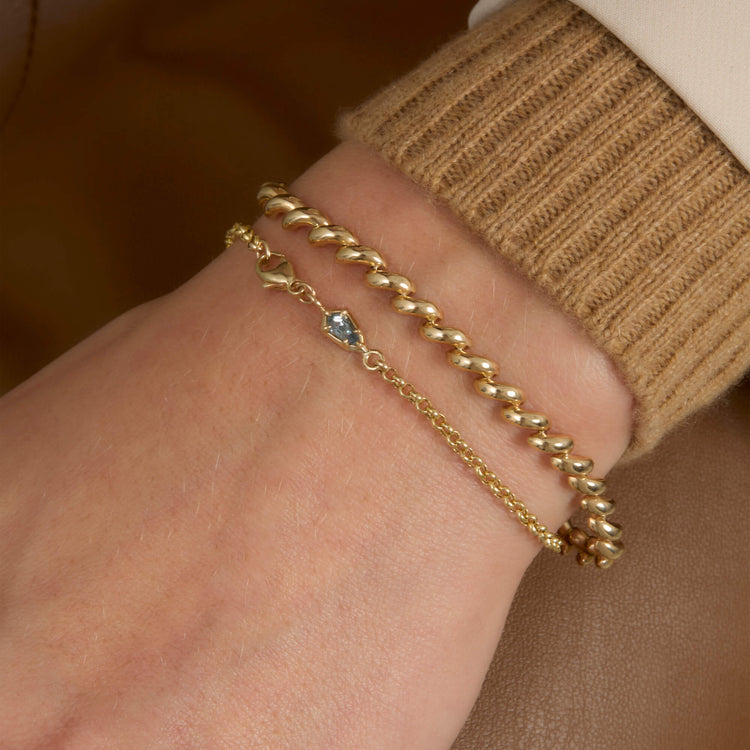 Model wearing Gold Portofino Bracelet with solid gold Stone and Strand jewelry