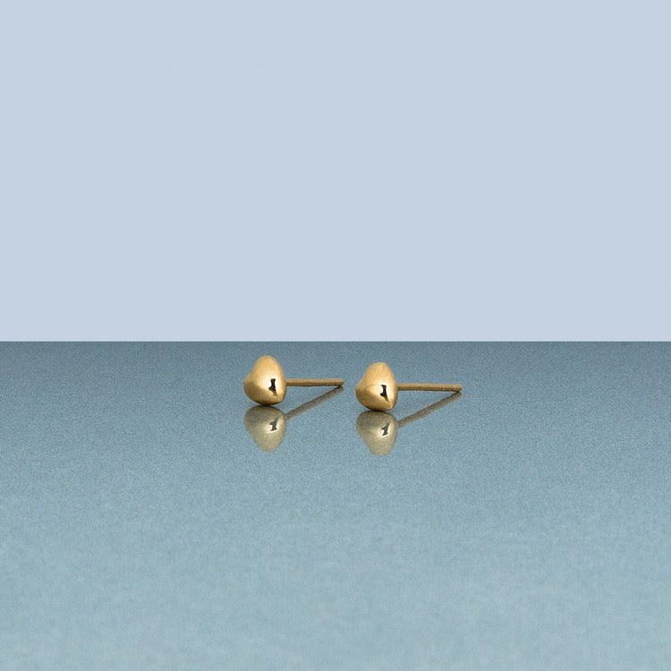 Stone and Strand 14K Yellow Gold Small Gold Heart Puff Stud Earrings Editorial Image