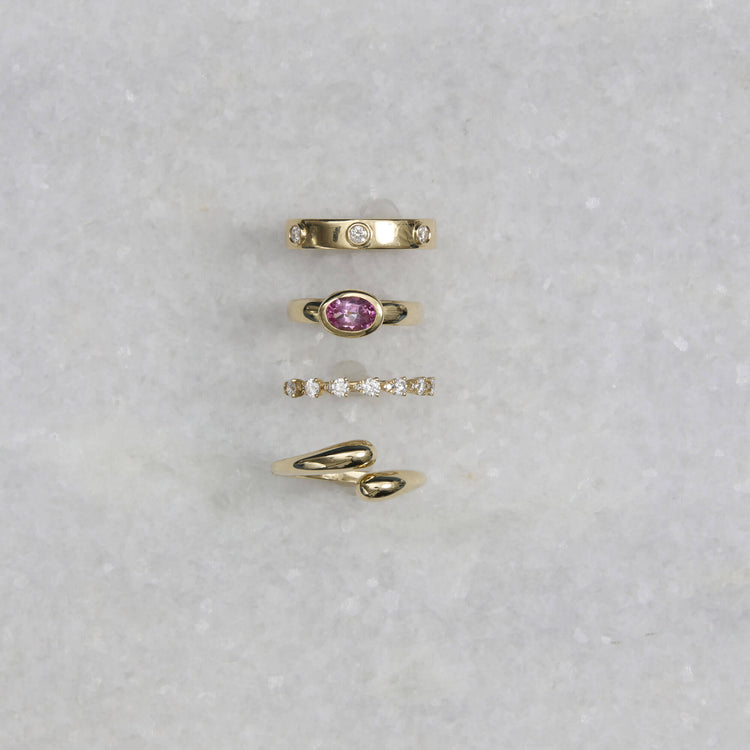 Still life image of Magenta Gallant Ring with Stone and Strand solid gold jewelry