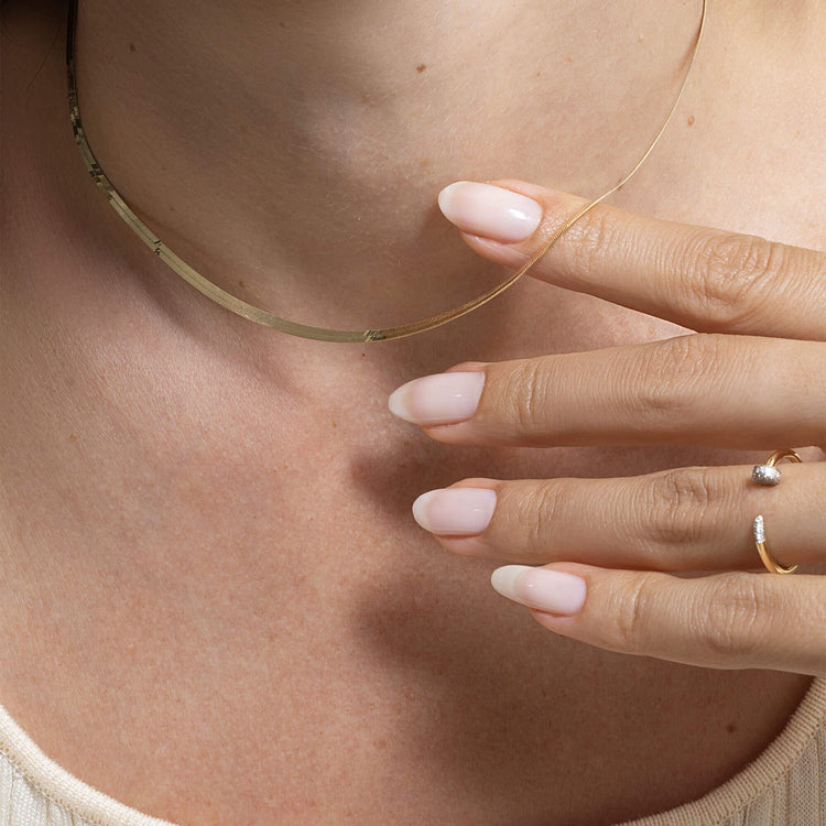 Model wearing Fine Nailed It Pave Diamond Ring with solid gold Stone and Strand jewelry