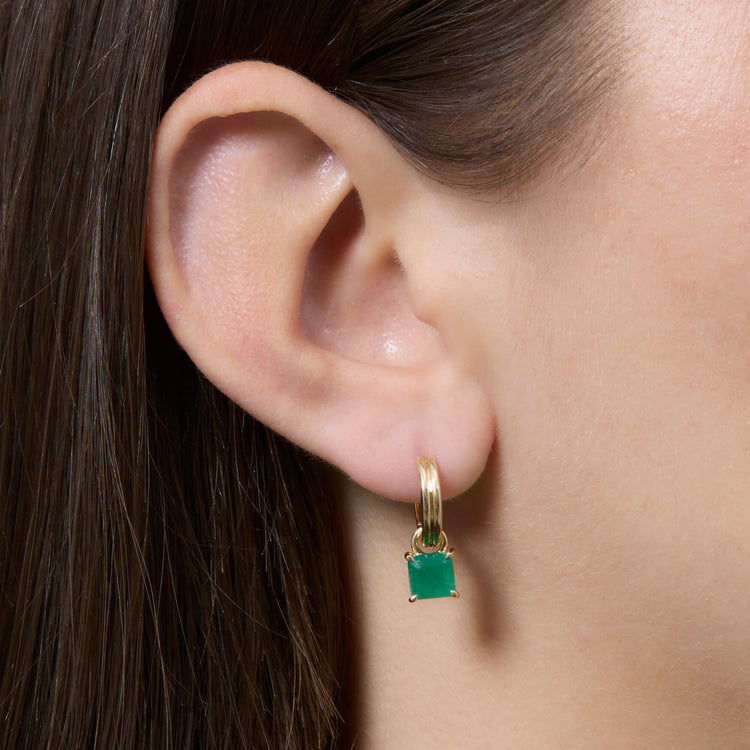 Image of 14K Yellow Gold Green Luxe Emerald Ridged Huggies on Models Ear