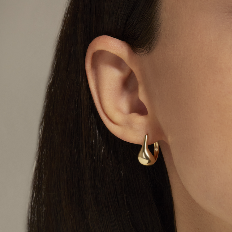 Image of 10K Yellow Gold Golden Droplet Huggies on Models Ear