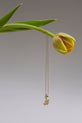 Still Life image of 14K Yellow Gold Woodstock Initial Charm Necklace with yellow flower