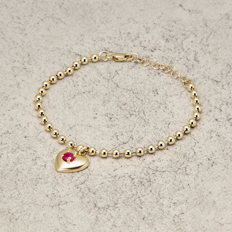 Stone and Strand 10K Yellow Gold Heart And Soul Ruby Bracelet Editorial Image