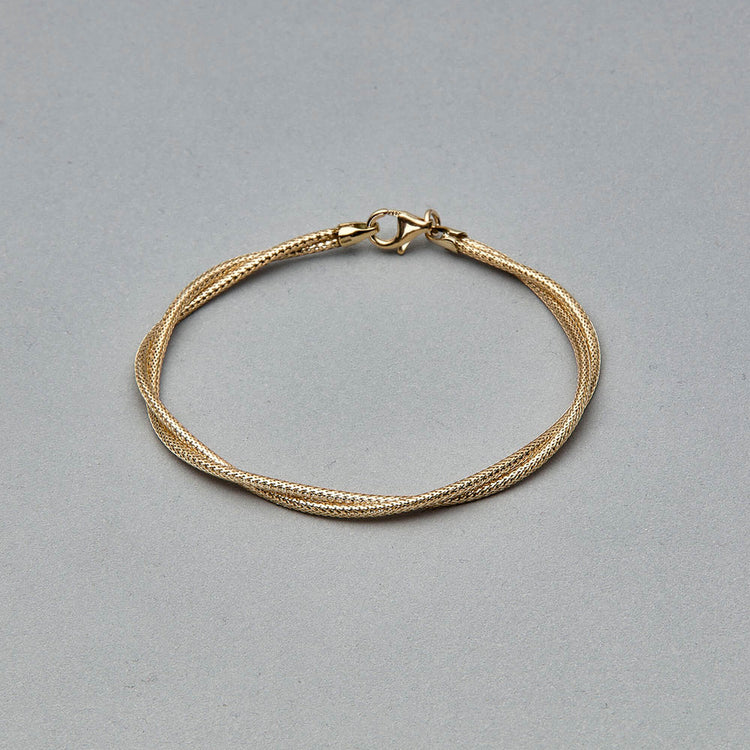 Stone and Strand 14K Yellow Gold Interwoven Gold Bracelet Editorial Image
