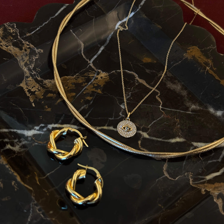 Still Life Image of 14K Yellow Gold Interwoven Gold Necklace with Stone and Strand Necklaces