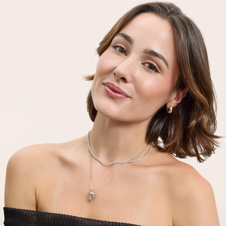 Model wearing Pave Pistachio Huggies with solid gold Stone and Strand jewelry