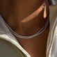 Model wearing LAB-Created Unflippable Tennis Necklace in White Gold with solid gold Stone and Strand jewelry