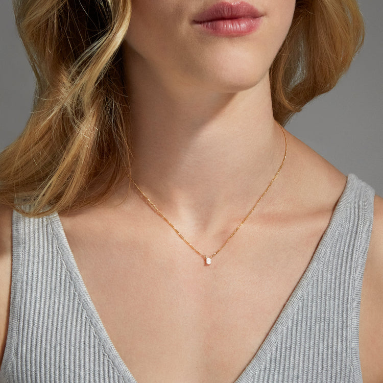 Image of 10K Yellow Gold Tiny Lab-Created Diamond Looking Glass Necklace on Models Neck