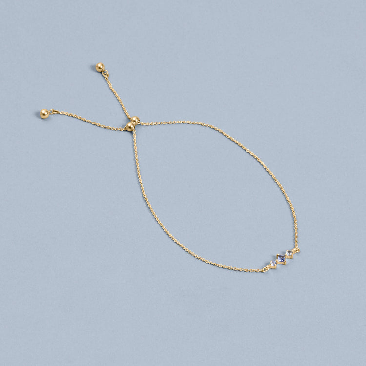 Stone and Strand 10K Yellow Gold Le Bleu Blue Sapphire Slider Bracelet Editorial Image