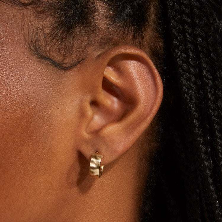 Image of 14K Yellow Gold Le Groove Huggies on Models Ear