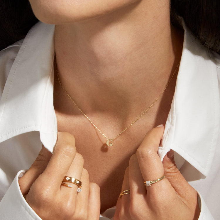 Model wearing Letterpress initial Necklace with solid gold Stone and Strand jewelry