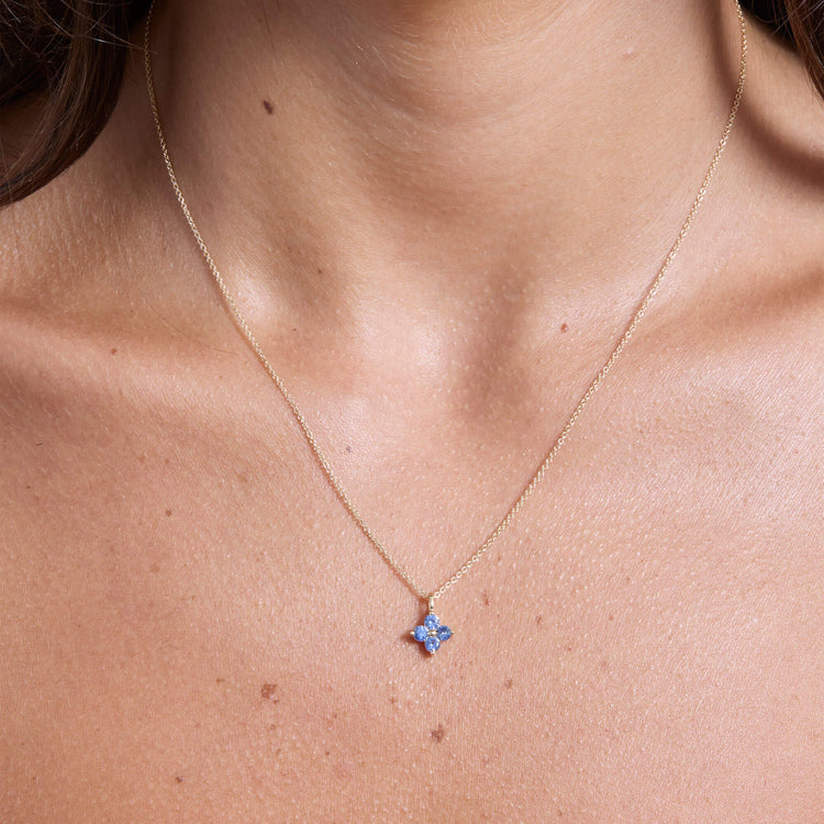 Image of 10K Yellow Gold Luckiest Clover Blue Sapphire Necklace on Models Neck