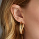 Image of 10K Yellow Gold Large Gold Glider Hoops on Models Ear