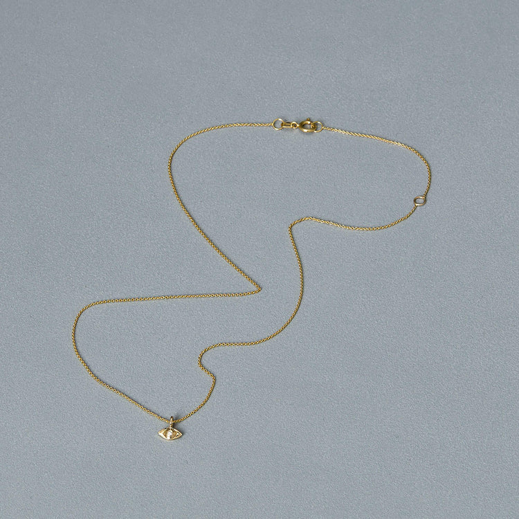 Stone and Strand 14K Yellow Gold Mini Evil Eye Welding Choker Editorial Image