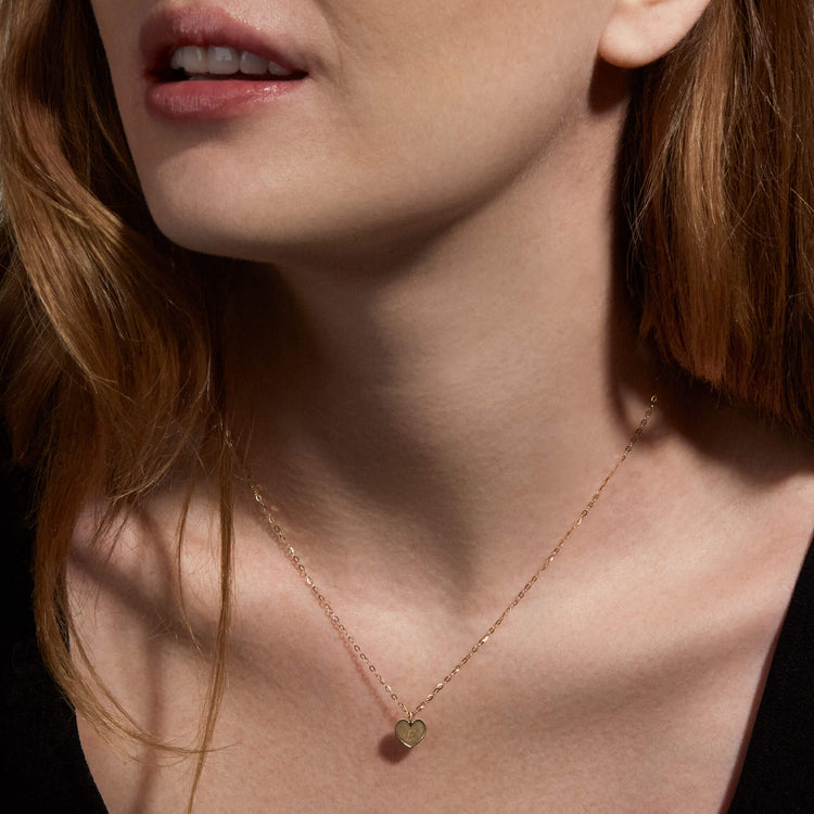 Image of 10K Yellow Gold Mini Heart Medallion Necklace on Models Neck