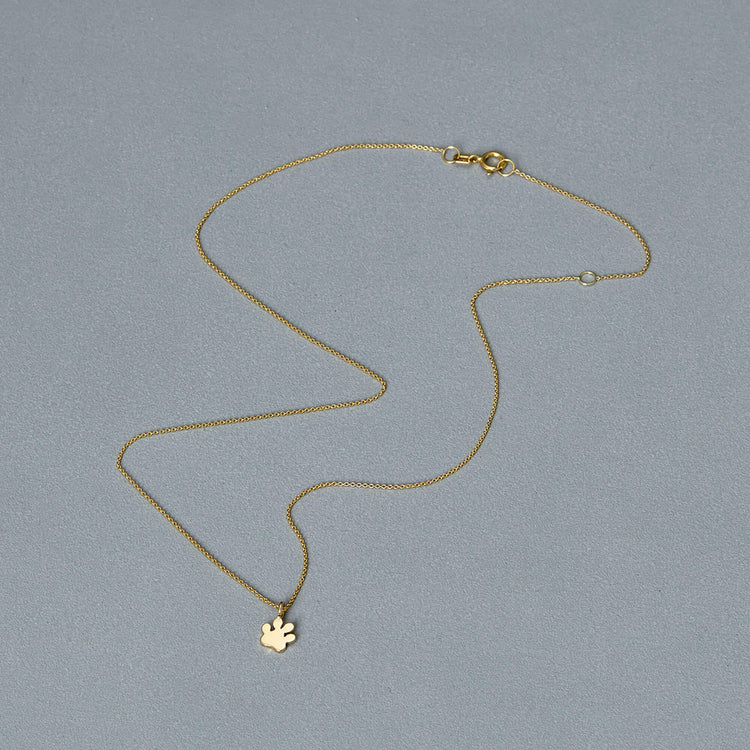 Stone and Strand 14K Yellow Gold Mini Pawprint Welding Choker Editorial Image