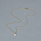 Stone and Strand 14K Yellow Gold Mini Pawprint Welding Choker Editorial Image
