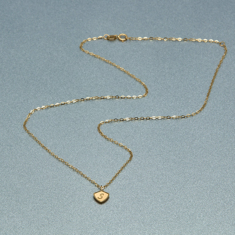 Stone and Strand 10K Yellow Gold Mini Shield Medallion Necklace Editorial Engraved Image