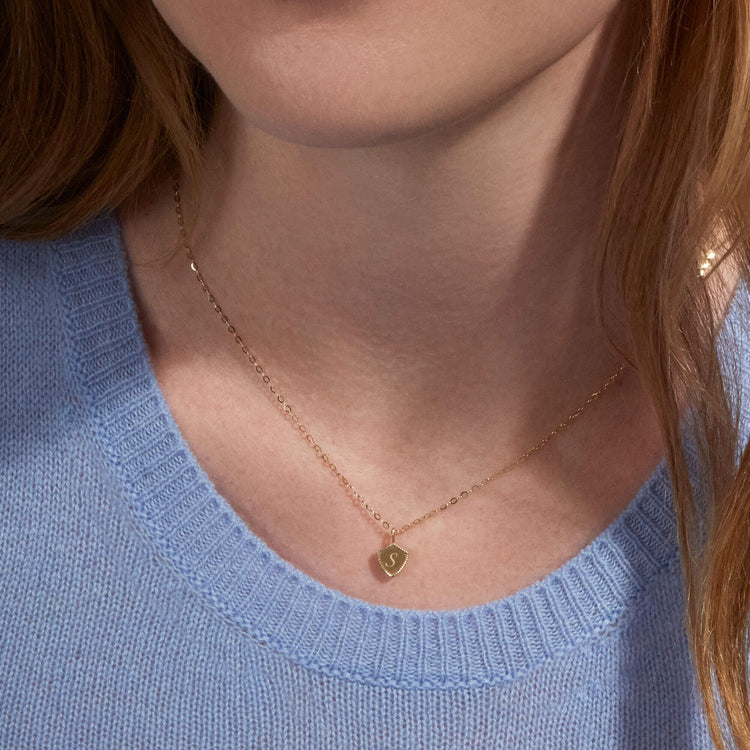 Image of 10K Yellow Gold Engraved Mini Shield Medallion Necklace on Models Neck