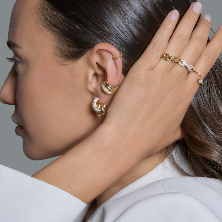 Model wearing Diamond Forme Knot Earrings with solid gold Stone and Strand jewelry
