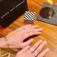Model wearing Elongated Cable Link Ring with solid gold Stone and Strand jewelry