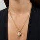 Model wearing Gold Salmon Charm with solid gold Stone and Strand jewelry