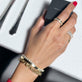 Model wearing Je Ne Regrette Gold Bangle with solid gold Stone and Strand jewelry