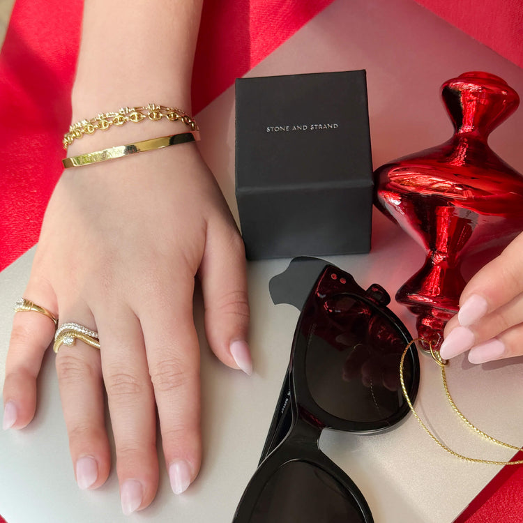 Model wearing Je Ne Regrette Gold Bangle with solid gold Stone and Strand jewelry