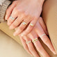 Model wearing LAB-Created Pave Silver Knife Edge Stacking Ring with solid gold Stone and Strand jewelry