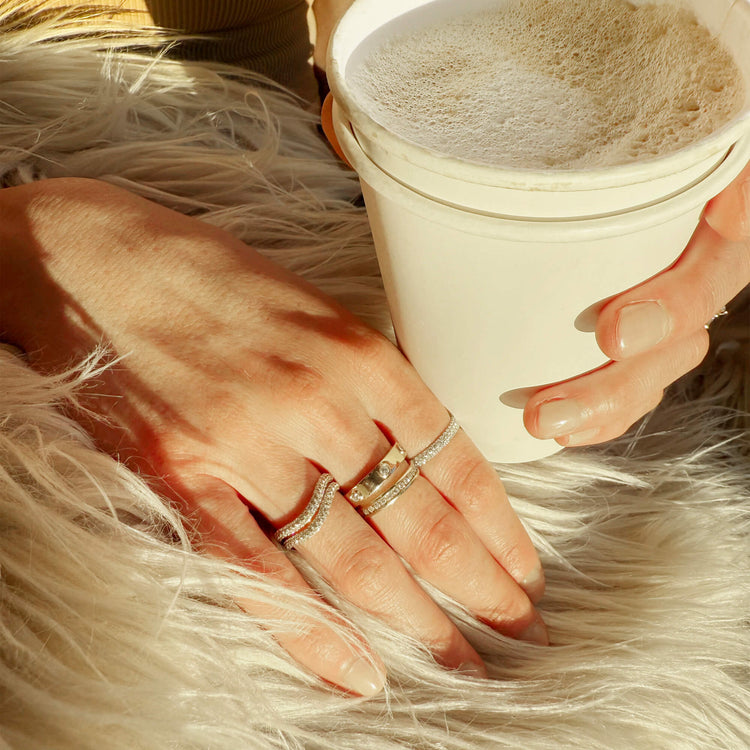 Model wearing LAB-Created Pave Silver Knife Edge Stacking Ring with solid gold Stone and Strand jewelry