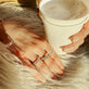 Model wearing LAB-Created Pave Silver Knife Edge Stacking Ring with solid gold Stone and Strand jewelry
