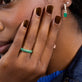 Model wearing Pave Emerald Cigar Band with solid gold Stone and Strand jewelry