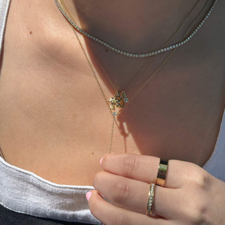 Model wearing Perfect Peat Diamond Lariat Necklace with solid gold Stone and Strand jewelry