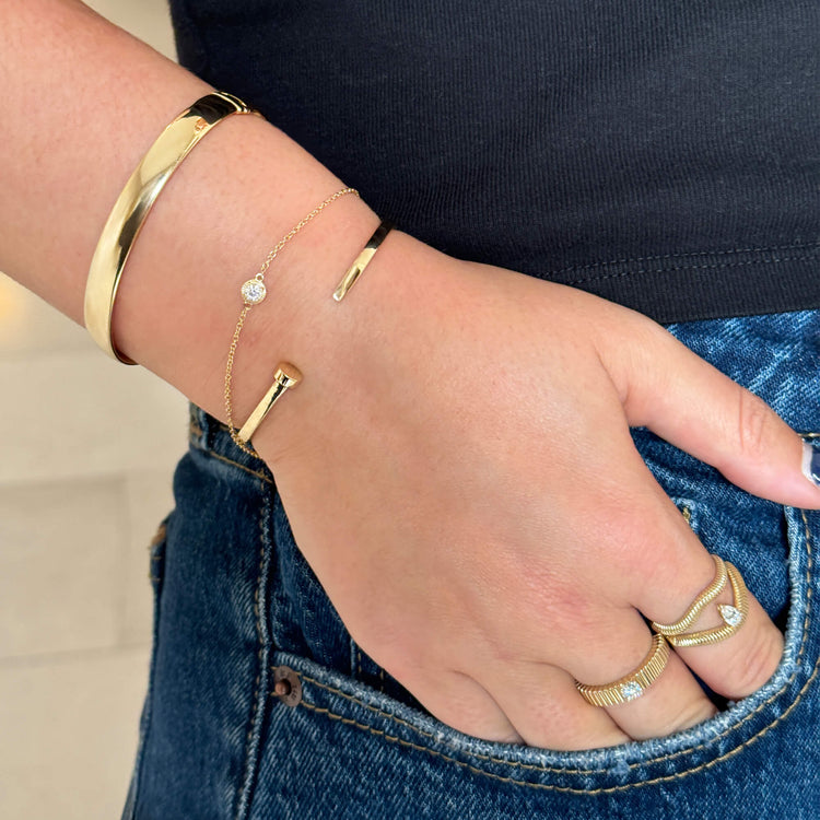 Model wearing Gold Cigar Bangle with solid gold Stone and Strand jewelry