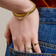 Model wearing Gold La Scala Bracelet with solid gold Stone and Strand jewelry