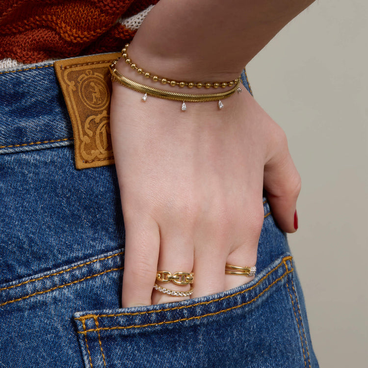 Model wearing Gold Ball Chain Bracelet with solid gold Stone and Strand jewelry