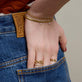 Model wearing Serpente Bracelet with solid gold Stone and Strand jewelry