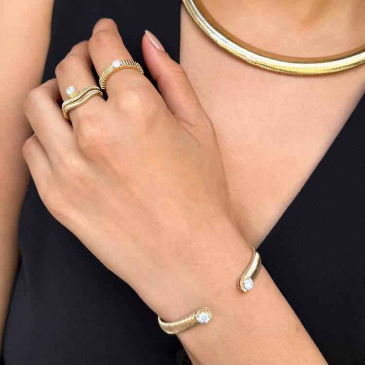 Model wearing Cher Ring with solid gold Stone and Strand jewelry