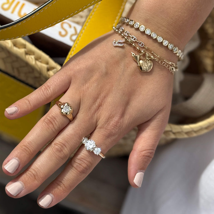Model wearing The Big Apple Charm with solid gold Stone and Strand jewelry