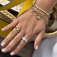 Model wearing The Big Apple Charm with solid gold Stone and Strand jewelry
