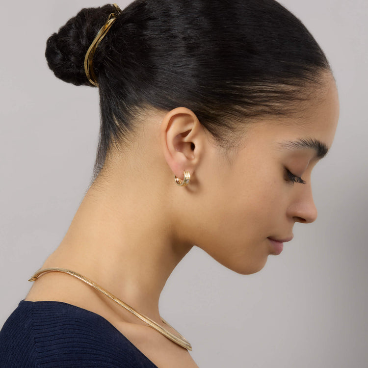 Model wearing Trio Ridge Diamond Huggies with solid gold Stone and Strand jewelry