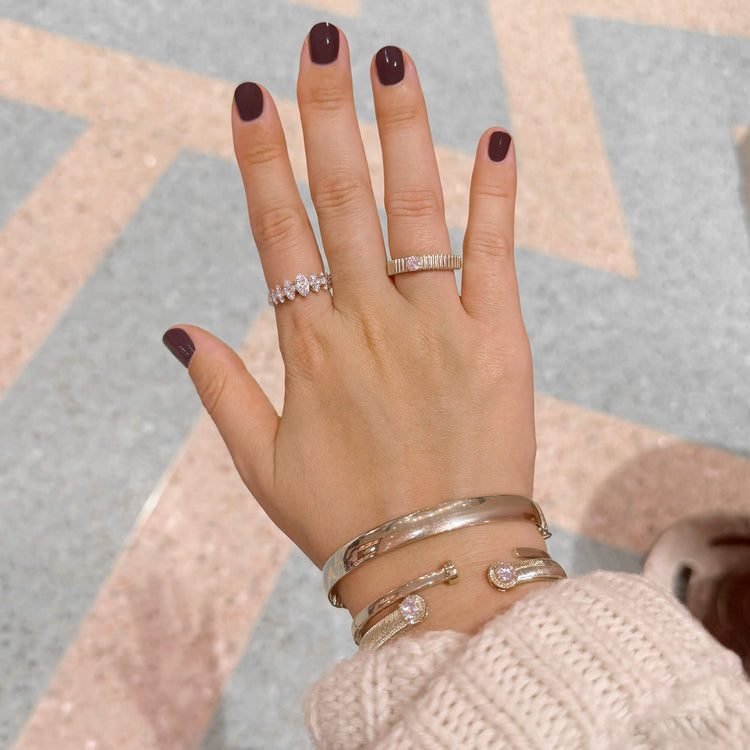 Model wearing Gold Cigar Bangle with solid gold Stone and Strand jewelry