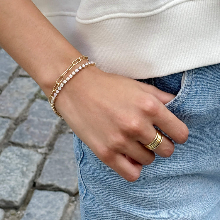 Model wearing Five Golden Rings with solid gold Stone and Strand jewelry