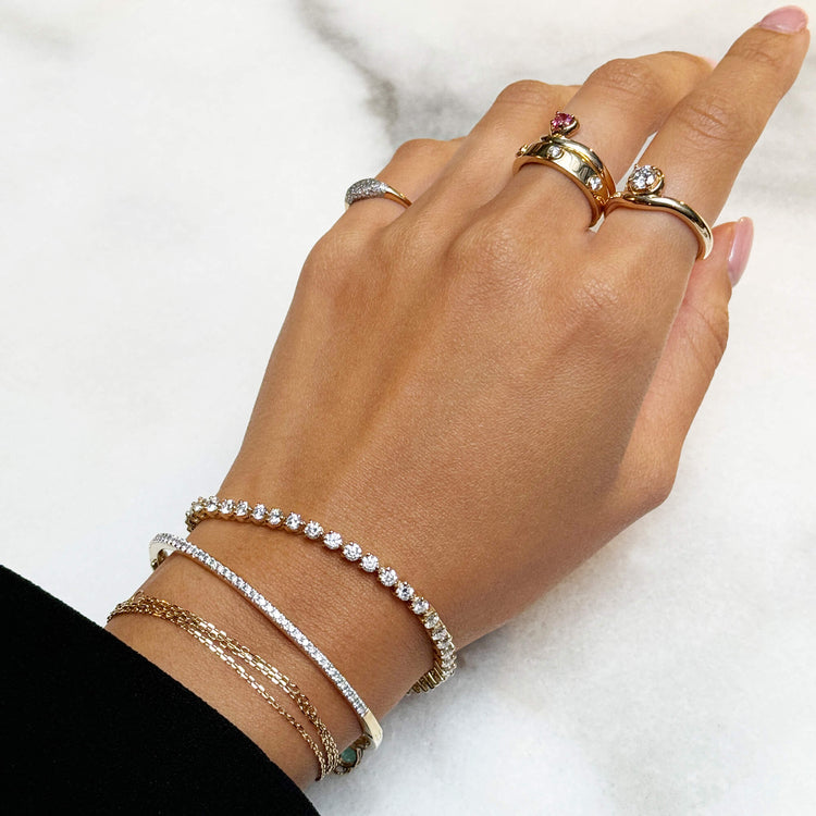 Model wearing Sweetheart Bonbon Merge Ring with solid gold Stone and Strand jewelry