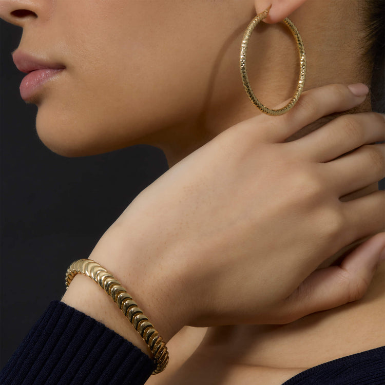 Model wearing Gold La Scala Bracelet with solid gold Stone and Strand jewelry